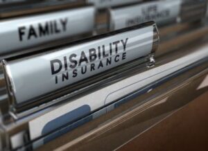 A photo of some files with labels, with the main file name in focus reading "Disability Insurance"