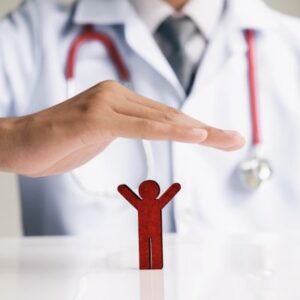 A photo of a person with a stethoscope hovering their hand over a small cut-out of a person, symbolizing health insurance