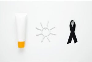 A picture of a bottle of sunscreen, a drawing of a sun in sunscreen cream, and a picture of a black ribbon that symbolizes skin cancer awareness